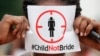 FILE - A woman protests against underage marriages in Lagos, Nigeria, July 20, 2013. 