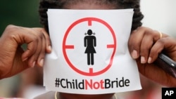 FILE - A woman protests against underage marriages in Lagos, Nigeria, July 20, 2013. The African Union is to convene a summit in Zambia this week with a view to ending child marriage. 