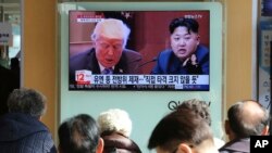 People watch a TV screen showing images of U.S. President Donald Trump, left, and North Korean leader Kim Jong Un at the Seoul Railway Station in Seoul, South Korea.