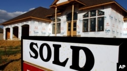 FILE -- A sold sign is posted in front of a new home in Springfield, Illinois.