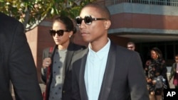 FILE - Pharrell Williams and an unidentified woman leave Los Angeles Federal Court after testifying at trial in Los Angeles, March 4, 2015 photo, . 