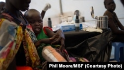 A boy who suffered severe burns to his leg is tended to by a Médecins Sans Frontières (MSF) doctor at the MSF clinic set up at the camp for displaced people in the grounds of the United Nations Mission to South Sudan (UNMISS) base in Juba, South Sudan, o