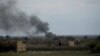 Smoke rises from a strike on Baghuz, the last of the Islamic State group's holdouts in Syria, March 22, 2019. 