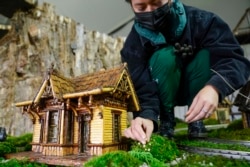 Margeaux Lim builds a miniature house preparing for the annual Holiday Train Show at the New York Botanical Garden in New York, Nov. 11, 2021.