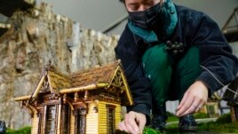 Margeaux Lim builds a miniature house preparing for the annual Holiday Train Show at the New York Botanical Garden in New York, Nov. 11, 2021.