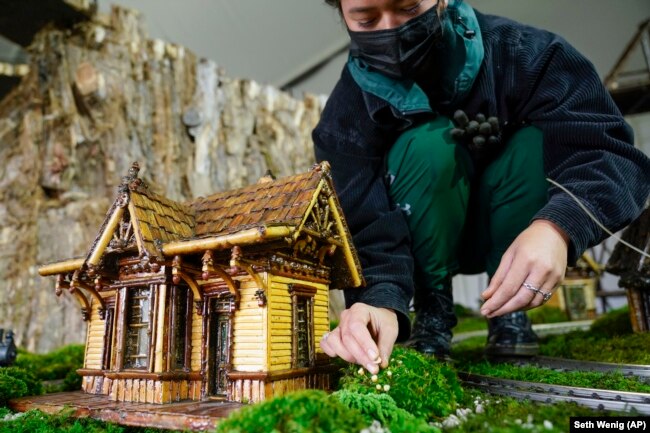 Margeaux Lim builds a miniature house preparing for the annual Holiday Train Show at the New York Botanical Garden in New York, Nov. 11, 2021.