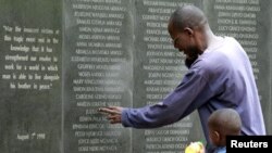 A survivor pays homage at a memorial wall listing the names of the those killed in the 1998 bombing of the U.S. Embassy in Nairobi. (Reuters)