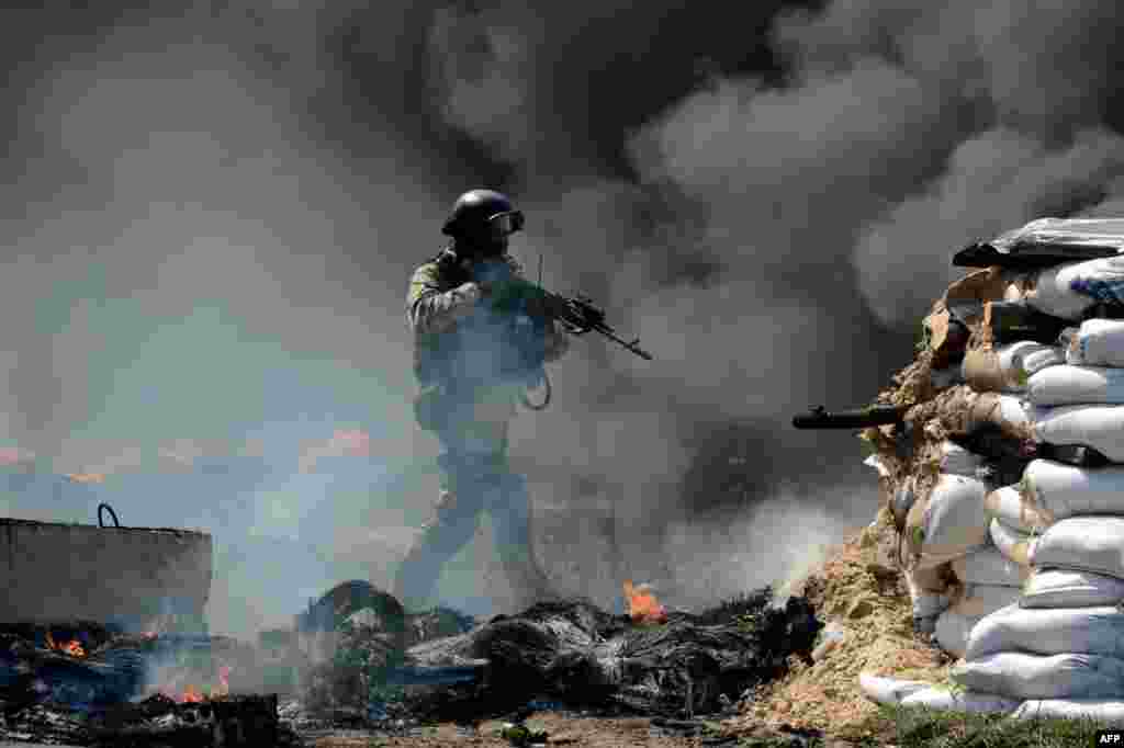 A member of the Ukrainian special forces takes position at an abandoned roadblock in the city of Slavyansk.