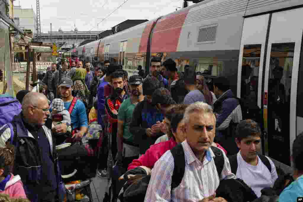 In Germany, more migrants arrive at the train station of the southern border town Passau, after they have been taken off a train by federal police for registration.