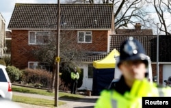 Police officers stand guard outside the home of Sergei Skripal in Salisbury, Britain, March 8, 2018.