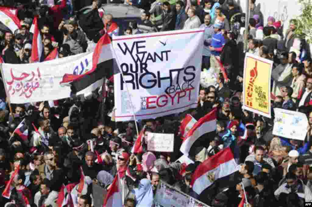 Thousands of Egyptian anti-government protesters march Alexandria, Egypt, Friday, Feb. 11, 2011. Egypt's military threw its weight Friday behind President Hosni Mubarak's plan to stay in office through September elections while protesters fanned out to th