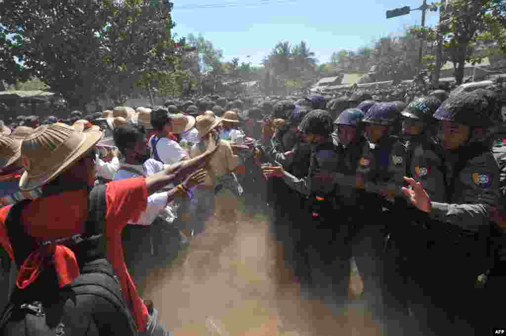 Myanmar riot police confront students during a protest march against an education bill in Letpadan town, some 130 kilometers (80 miles) north of Yangon.