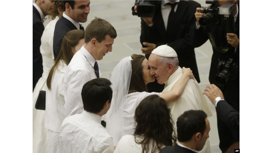 Pope Francis greets newlyweds during the general audience at the Vatican, Aug. 5, 2015. Pope Francis says divorced Catholics who remarry and their children deserve better treatment from the Catholic church.