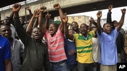 Angry youths protest and shout slogan in Lagos, Nigeria, Monday, Jan. 16, 2012. For the first time since protests erupted over spiraling fuel prices, soldiers barricaded key roads Monday in Nigeria's two biggest cities as the president offered a concessio