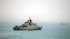 FILE - Iranian warship Alborz, foreground, is seen in the Strait of Hormuz, April 7, 2015. 