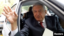 Andres Manuel Lopez Obrador, presidential pre-candidate of the National Regeneration Movement (MORENA), waves as he leaves an event during which he unveiled his anti-corruption plan he will put in place if he wins this year's election, in Mexico City, Jan