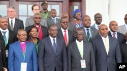 Uganda VP Edward Sekandi, second left, front row, Uganda PM Ruhakana Rugunda, right, and East African Community Secretary-General Dr. Sezibwera, second right, pose with others, during Burundi peace talks, at Entebbe State House, Dec. 28, 2015.