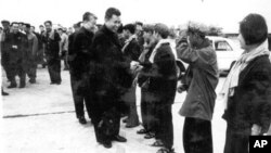 In this undated photo provided by Documentation Center of Cambodia, the late Khmer Rouge leader Pol Pot, center, greets Khmer Rouge cadre in Phnom Penh airport, Cambodia. 