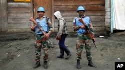 FILE - Two MONUSCO UN soldiers stand guard in Goma's port.