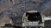 FILE - Azerbaijani soldiers sit in a military truck taking them to their military tent camp, in Kalbajar, Azerbaijan, Dec. 2, 2020. 