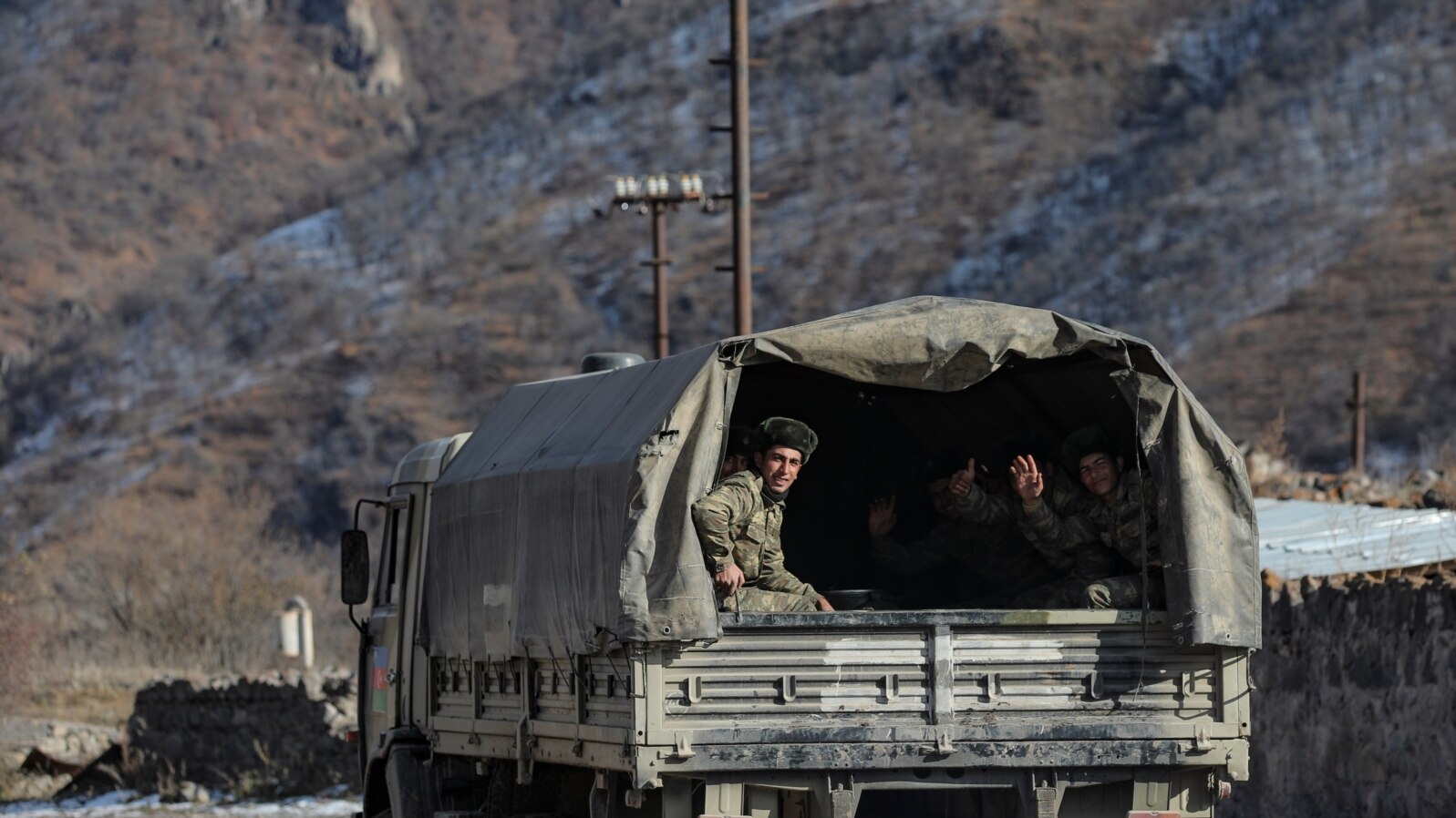 FILE - Azerbaijani soldiers sit in a military truck taking them to their military tent camp, in Kalbajar, Azerbaijan, Dec. 2, 2020. 