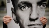 A man holds a poster with a portrait of opposition leader Alexey Navalny during a protest in front of the Russian embassy in Berlin, Germany.&nbsp;Navalny, who crusaded against official corruption and staged massive anti-Kremlin protests as President Vladimir Putin&rsquo;s fiercest foe, died Friday in the Arctic penal colony where he was serving a 19-year sentence, Russia&rsquo;s prison agency said.