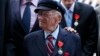 FILE - Benjamin B. Ferencz pose for a picture after he received the Legion of Honor Insignia from French minister of Defense Jean-Yves Le Drian during an awards ceremony to honor World War II veterans in New York, July 3, 2015.