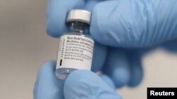 FILE - A vial of the Pfizer/BioNTech COVID-19 vaccine is seen ahead of being administered at the Royal Victoria Hospital, on the first day of the largest immunisation programme in the British history, in Belfast, Northern Ireland December 8, 2020.