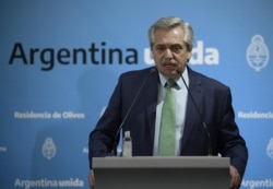 FILE - Argentina's President Alberto Fernandez talks during a press conference at the presidential residence in Olivos, Buenos Aires, March 19, 2020.