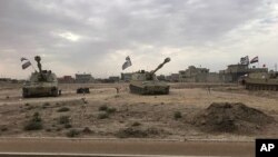 Iraqi tanks deploy in the village of Bashir, south of Kirkuk, Iraq, Oct. 13, 2017. 