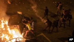 Protesters barricade during clashes with police in Barcelona. (AP)