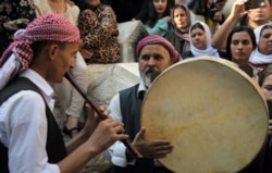 Iraqi Yazidis play traditional music at the Temple of Lalish, in a valley near the Kurdish city of Dohuk, about 430km northwest of the Iraqi capital Baghdad, Oct. 9, 2019.