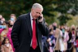 FILE - Then-White House chief of staff Mark Meadows speaks on a phone on the South Lawn of the White House in Washington, Oct. 30, 2020.