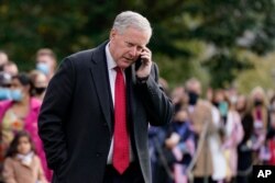 FILE - Then-White House chief of staff Mark Meadows speaks on a phone on the South Lawn of the White House in Washington, Oct. 30, 2020.