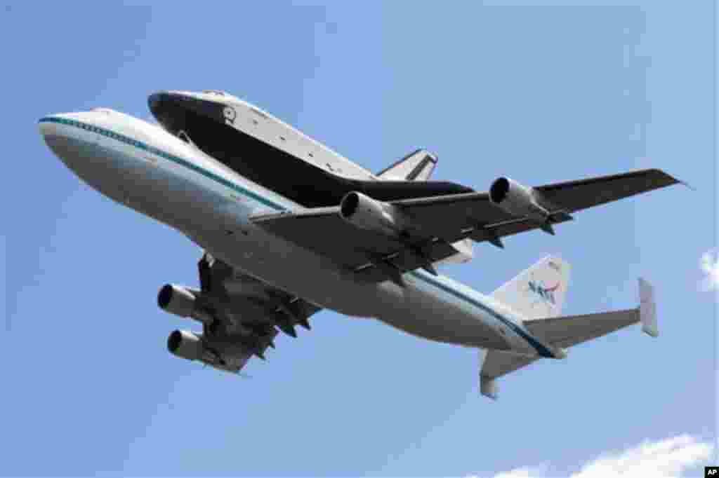 Space shuttle Enterprise, riding on the back of the NASA 747 Shuttle Carrier Aircraft flies over JFK International Airport, Friday, April 27, 2012. Enterprise is eventually going to make its new home in New York City at the Intrepid Sea, Air and Space Mus