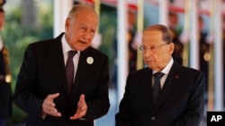 Arab League Secretary-General, Ahmed Aboul Gheit, left, speaks with Lebanese President Michel Aoun, right, at Rafik Hariri international airport in Beirut, Lebanon, Jan. 20, 2019. 