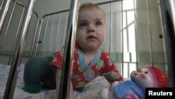 One-year-old Artur and his two-year-old brother Mark (not pictured) were brought to a local hospital in Russia's Siberian city of Krasnoyarskl by the police due to neglect by their parents. They are currently waiting to be put up for adoption, March 23, 2011.