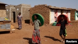 FILE - Eritrean refugee children walk within Mai-Aini refugee camp near the Eritrean boarder in the Tigrai region in Ethiopia, Feb. 10, 2016. 