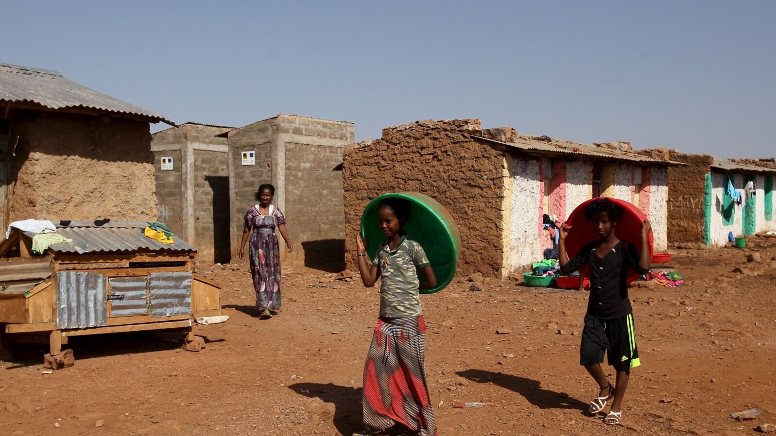 FILE - Eritrean refugee children walk within Mai-Aini refugee camp near the Eritrean boarder in the Tigrai region in Ethiopia, Feb. 10, 2016. 
