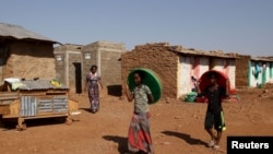 FILE - Eritrean refugee children walk within Mai-Aini refugee camp near the Eritrean boarder in the Tigrai region in Ethiopia, Feb. 10, 2016. 