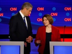 Rep. Tim Ryan, D-Ohio, and Sen. Amy Klobuchar, D-Minn. talk during a break in the first of two Democratic presidential primary debates hosted by CNN Tuesday, July 30, 2019, in the Fox Theatre in Detroit.
