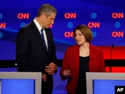 Rep. Tim Ryan, D-Ohio, and Sen. Amy Klobuchar, D-Minn. talk during a break in the first of two Democratic presidential primary debates hosted by CNN Tuesday, July 30, 2019, in the Fox Theatre in Detroit.