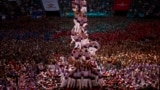 Members of "Colla Jove de Tarragona" fall before completing a "Castell" or human tower, during the 29th Human Tower Competition in Tarragona, Spain, Oct. 6, 2024. 