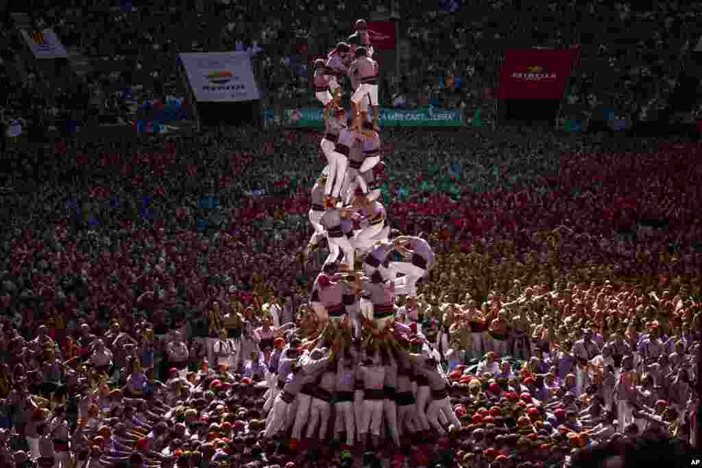 Members of &quot;Colla Jove de Tarragona&quot; fall before completing a &quot;Castell&quot; or human tower, during the 29th Human Tower Competition in Tarragona, Spain.