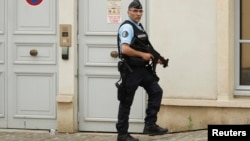 A French policeman stands outside team England's hotel for the UEFA 2016 European Championship, in Chantilly, France, June 8, 2016. 