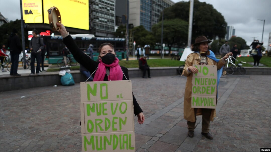FILE - Anti-quarantine demonstrators wear signs reading "no to the new world order", protesting quarantine measures in Buenos Aires, May 30, 2020. 