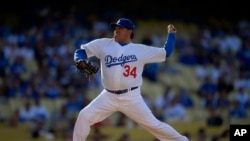 FILE - Fernando Valenzuela throws to the sheet  during the Old-Timers shot   game, successful  Los Angeles, June 8, 2013.