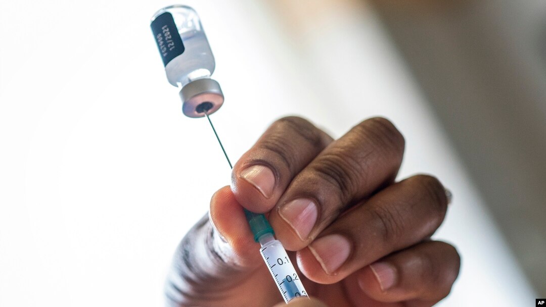 A nurse fills a syringe with COVID-19 vaccine at Soweto's Baragwanath hospital, South Africa, Dec. 13, 2021.