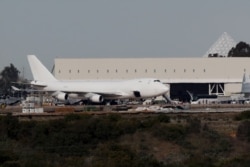 A plane carrying evacuees from the virus zone in China arrives at Marine Corps Air Station Miramar, Feb. 5, 2020, in San Diego, California.