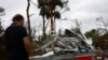 A person looks at damage caused by a tornado after Hurricane Milton made landfall, in Lakewood Park, Florida, Oct. 10, 2024.